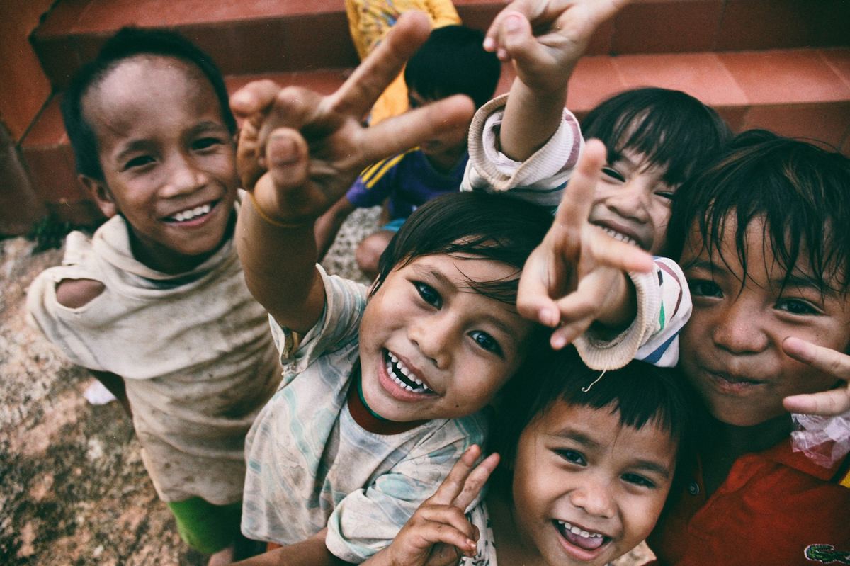 Joyful children laughing and reaching toward the camera